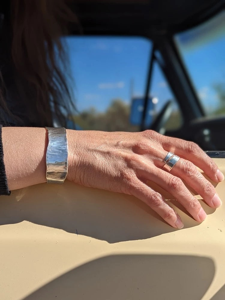 woman in vintage truck wearing ring and bracelet